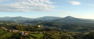 Aerial picture of an eastern Styrian landscape featuring the southern rim of the alps and the Kulm in the foreground